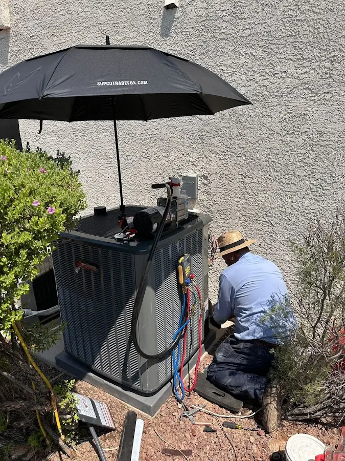 HVAC technician performing outdoor AC maintenance in South Huntingdon